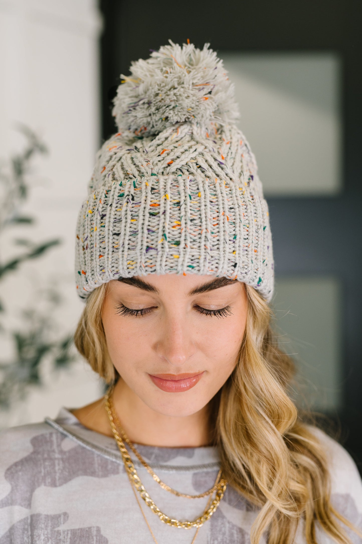 Cover Your Ears Pom Pom Beanie in speckled cable knit, stretchy and cozy winter accessory from Bethany’s Chic Boutique