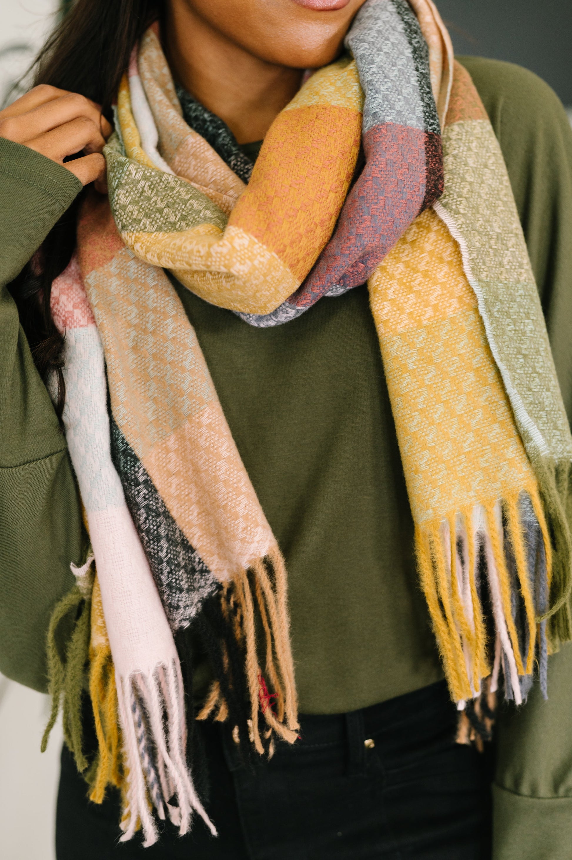 Checkered fringe scarf in green, yellow, and pink made from brushed fabric for cozy layering