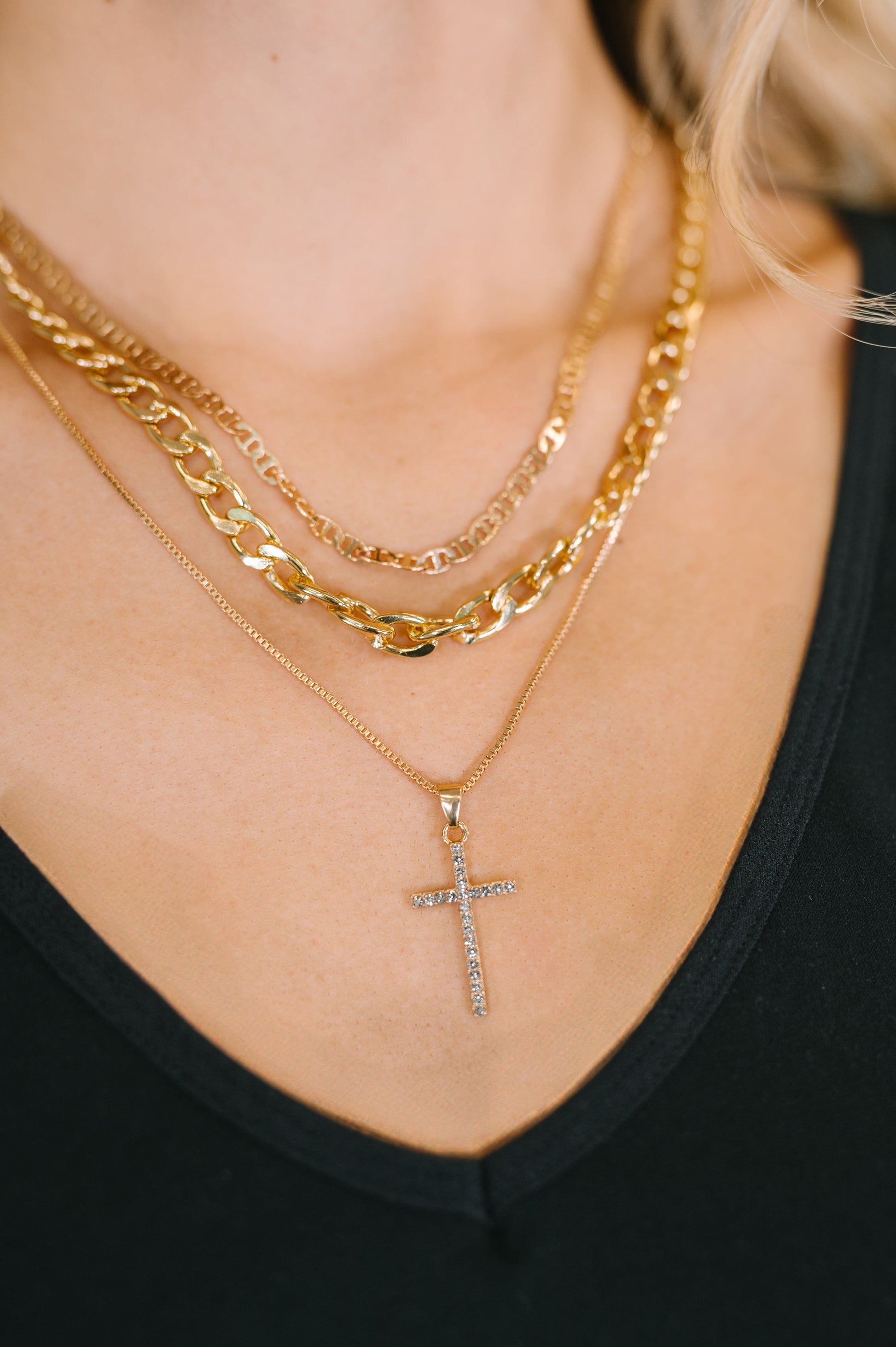 Layered Gold faith necklace with pavé cross pendant and mixed chain styles