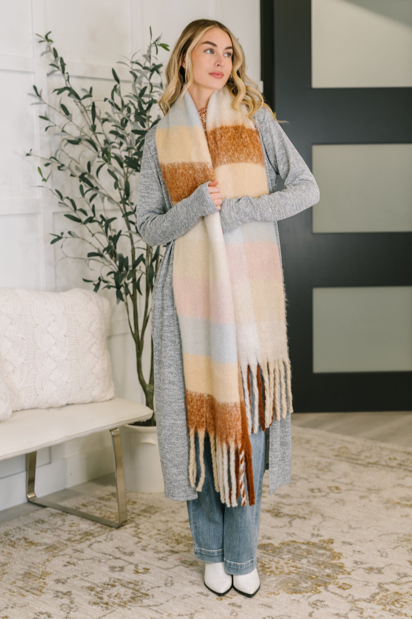 Wanderlust Wrap oversized plaid fringe scarf made from brushed fabric, perfect for layering as a cozy scarf or shawl from Bethany’s Chic Boutique